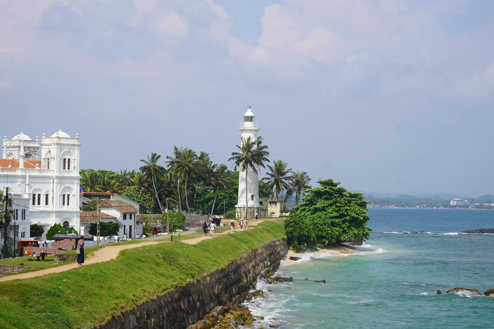 Galle Fort's lighthouse and Meeran Mosque on the ramparts above a turquoise sea