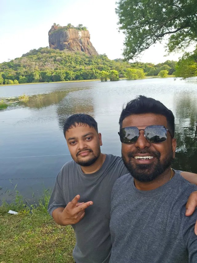 Dhanuka and a guest at Sigiriya lake, the rock rising behind them